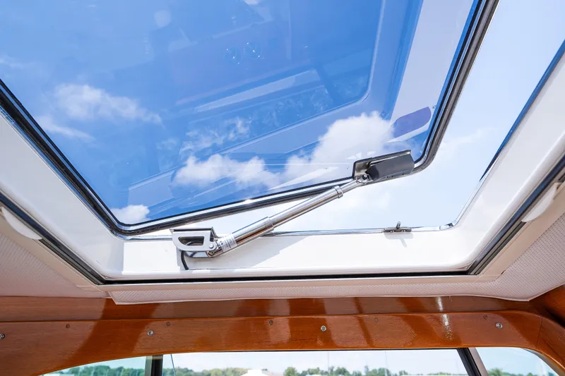 Slide: The Image of Hinckley Picnic Boat 37 MKIII 2020 skylight with blue sky reflection. - 29