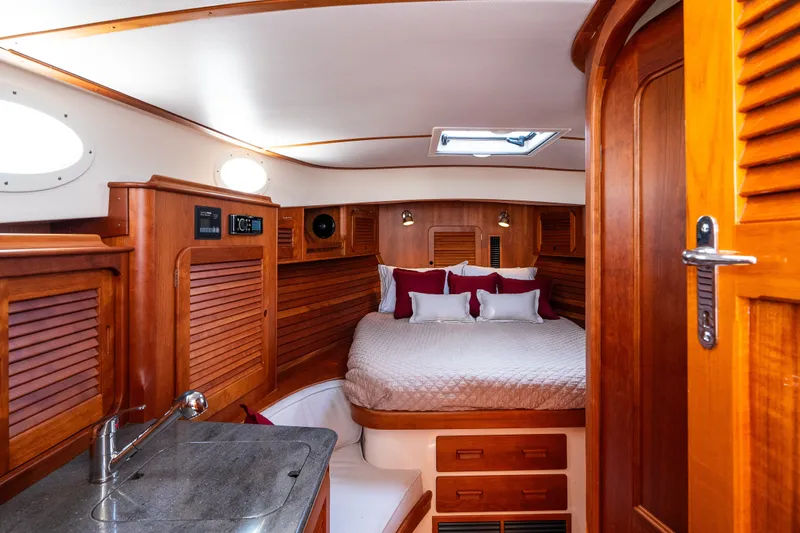 Slide: The Image of 2020 Hinckley Picnic Boat 37 MKIII cabin with wooden interior and cozy bed. - 40