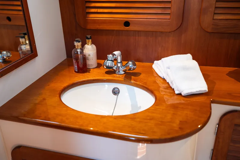 Slide: The Image of Luxurious wooden vanity with sink in 2020 Hinckley Picnic Boat 37 MKIII bathroom. - 48