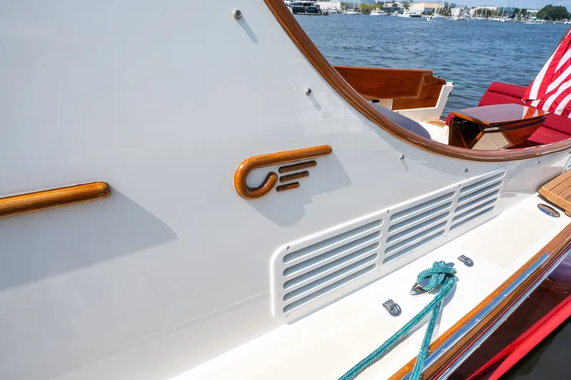 Slide: The Image of 2020 Hinckley Picnic Boat 37 MKIII with wooden accents and American flag on deck. - 35