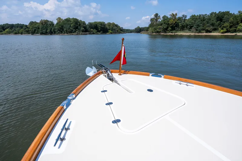 Slide: The Image of Bow of 2020 Hinckley Picnic Boat 37 MKIII on a serene river. - 33