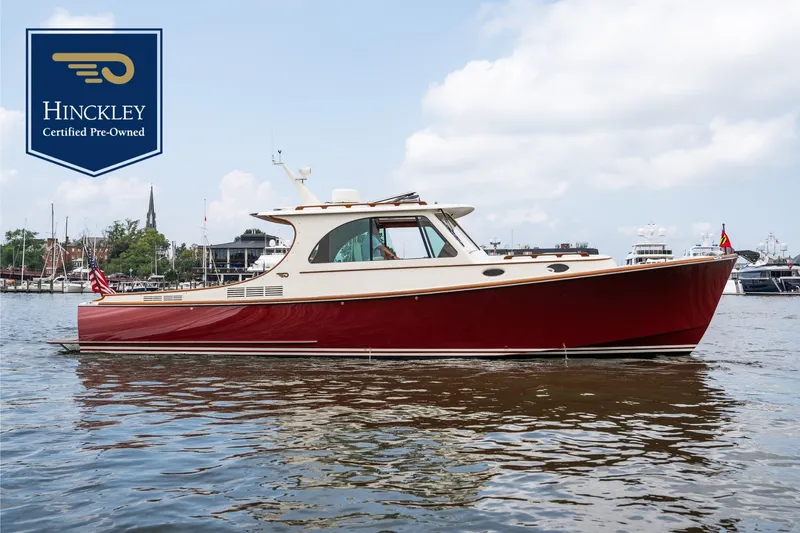 The Image of 2020 Hinckley Picnic Boat 37 MKIII on calm water, featuring elegant design and red hull. - 0
