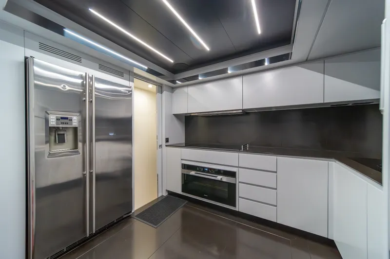 Slide: The Image of Modern kitchen interior on 2021 Riva 110' Dolcevita yacht, featuring sleek cabinetry and stainless steel appliances. - 47
