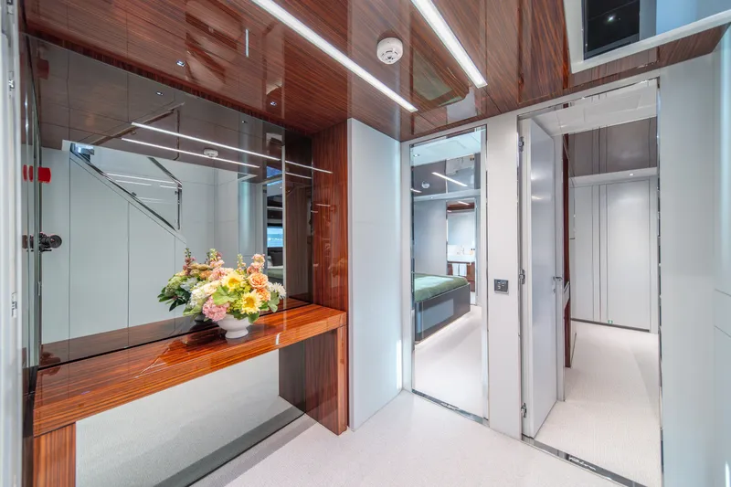 Slide: The Image of Luxurious interior of 2021 Riva 110' Dolcevita yacht with elegant wood finishes and floral arrangement. - 65