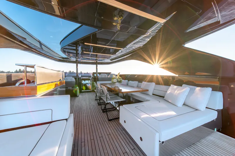 Slide: The Image of Luxurious 2021 Riva 110' Dolcevita yacht deck with elegant seating and sunset view. - 39