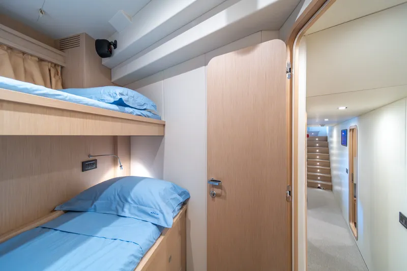 Slide: The Image of Interior of 2021 Riva 110' Dolcevita yacht with bunk beds and hallway view. - 81
