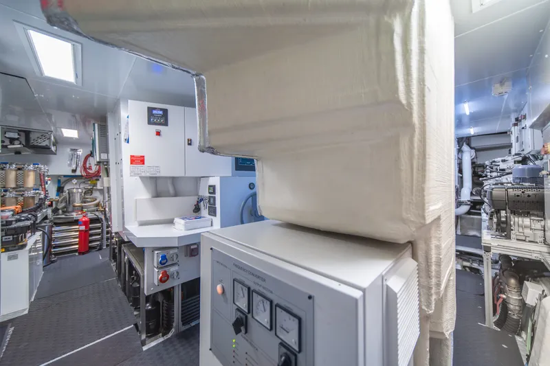 Slide: The Image of Engine room of 2021 Riva 110' Dolcevita yacht, showcasing advanced machinery and control panels. - 92