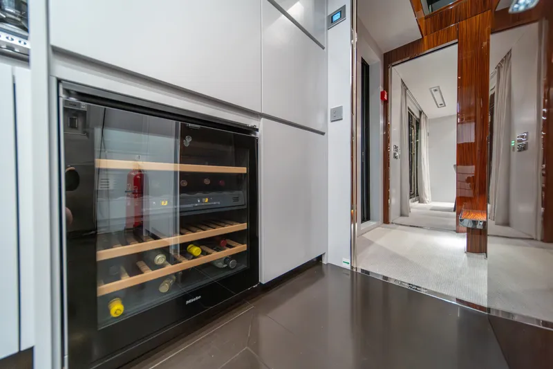 Slide: The Image of Luxurious interior of 2021 Riva 110' Dolcevita yacht featuring a sleek wine cooler. - 48