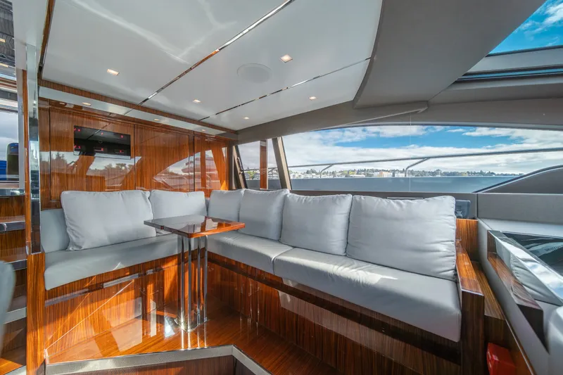 Slide: The Image of Luxurious interior of 2021 Riva 110' Dolcevita yacht with plush seating and panoramic windows. - 51