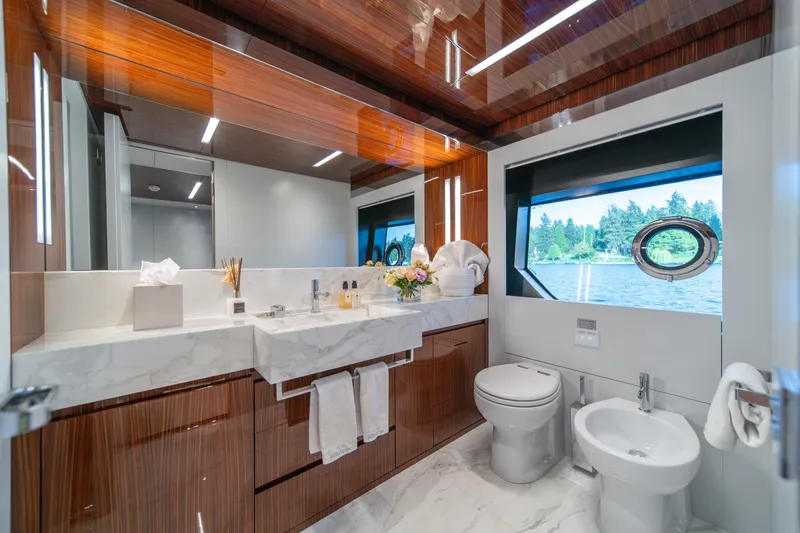 Slide: The Image of Luxurious bathroom on 2021 Riva 110' Dolcevita yacht with marble accents and scenic window view. - 70