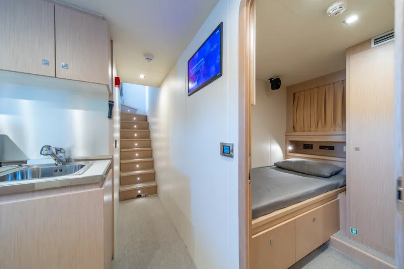 Slide: The Image of Luxurious interior of 2021 Riva 110' Dolcevita yacht featuring a cozy bedroom and kitchenette. - 75