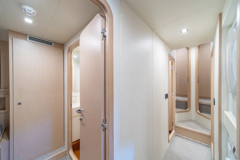 Slide: The Image of Interior of 2021 Riva 110' Dolcevita yacht, featuring modern wood paneling and sleek design. - 79