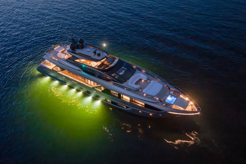 Slide: The Image of Luxurious 2021 Riva 110' Dolcevita yacht illuminated on serene water at night. - 29