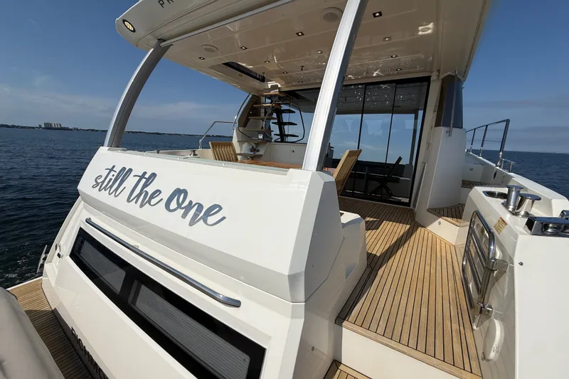 Slide: The Image of Prestige 630 yacht, 2017 model, with "still the one" text, on open water. - 15