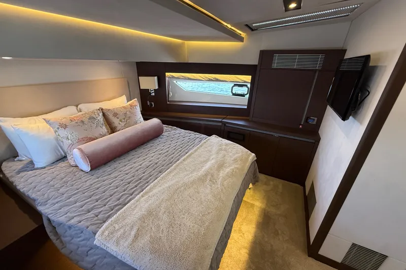 Slide: The Image of Luxurious bedroom interior of a 2017 Prestige 630 yacht with elegant bedding and modern decor. - 34