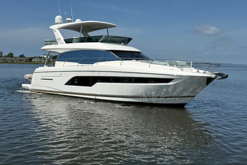 The Image of Luxury 2017 Prestige 630 yacht cruising on calm waters under a clear blue sky. - 0