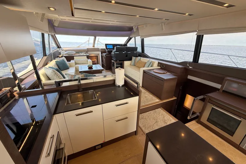 Slide: The Image of Luxurious interior of a 2017 Prestige 630 yacht with modern kitchen and seating area. - 21