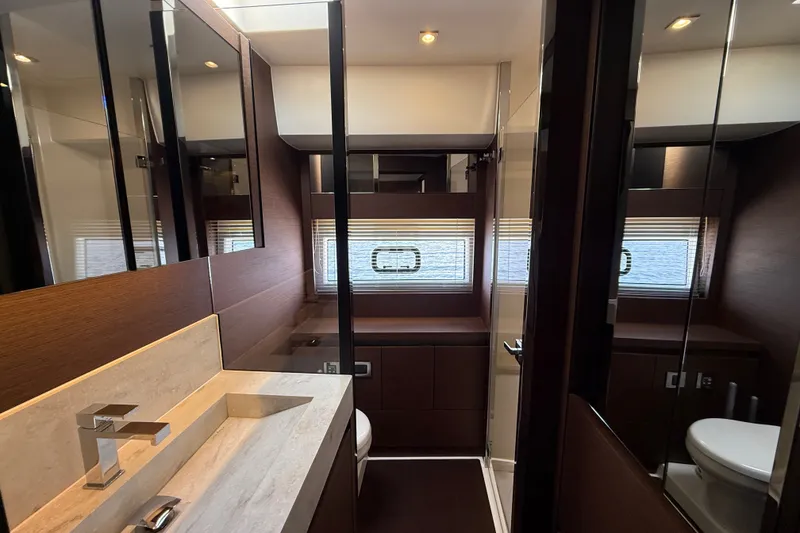 Slide: The Image of Luxurious bathroom interior of a 2017 Prestige 630 yacht, featuring modern fixtures and wood accents. - 37