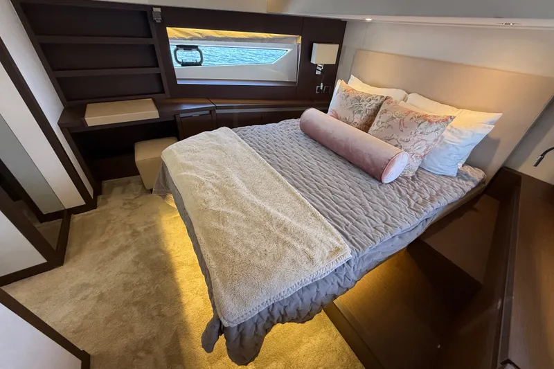 Slide: The Image of Luxurious bedroom interior of 2017 Prestige 630 yacht with elegant bedding and window view. - 35