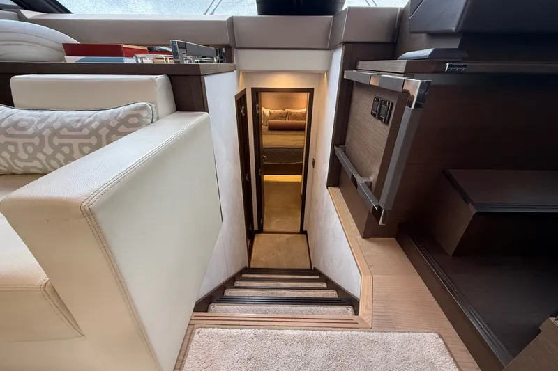 Slide: The Image of Luxurious interior of a 2017 Prestige 630 yacht, featuring elegant stairs and cozy seating. - 33