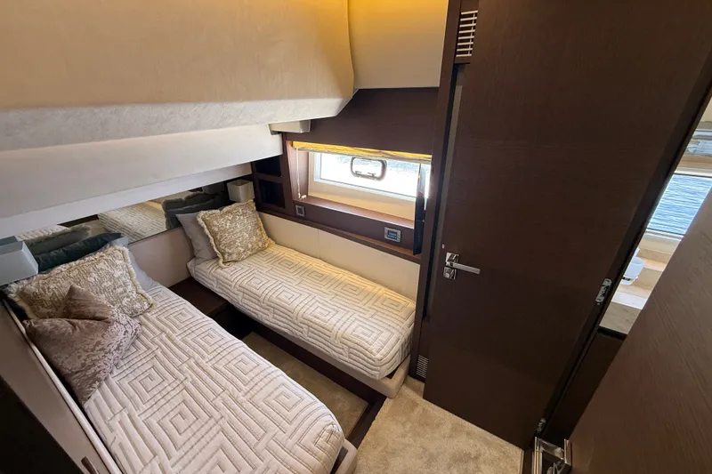 Slide: The Image of Luxurious twin cabin interior on a 2017 Prestige 630 yacht, featuring elegant bedding and decor. - 39
