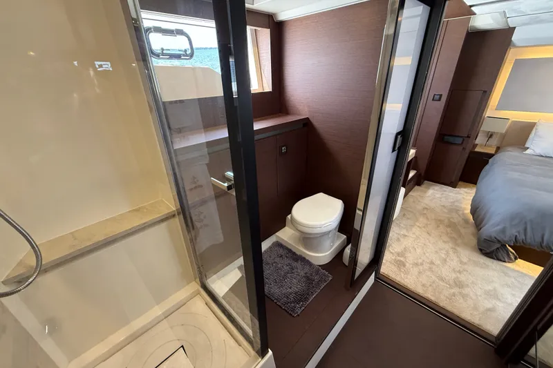 Slide: The Image of Luxurious 2017 Prestige 630 yacht interior featuring a modern bathroom and cozy bedroom. - 31