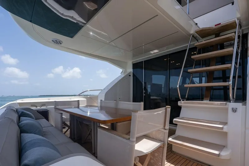 Slide: The Image of Luxurious 2020 Ferretti Yachts 670 deck with seating and stairs, ocean view. - 23
