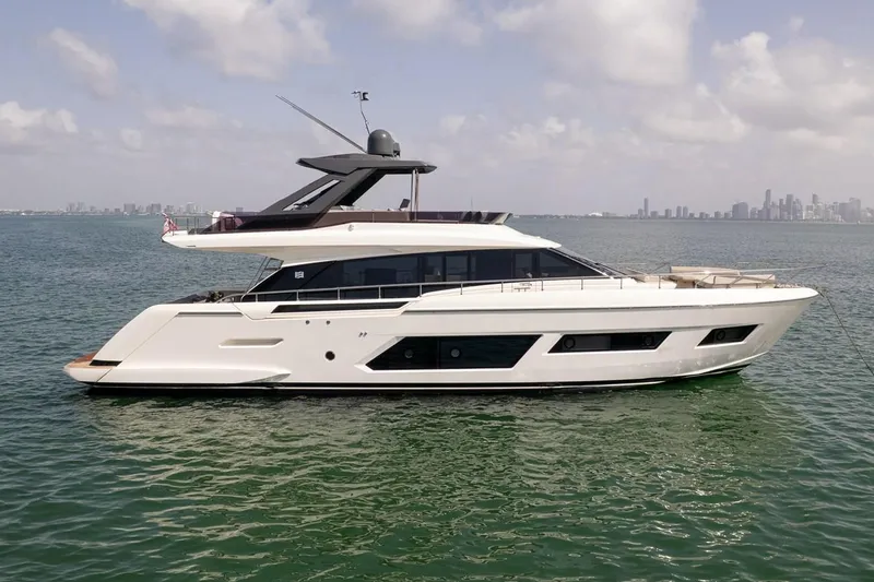 Slide: The Image of 2020 Ferretti Yachts 670 luxury yacht on calm water with city skyline background. - 8