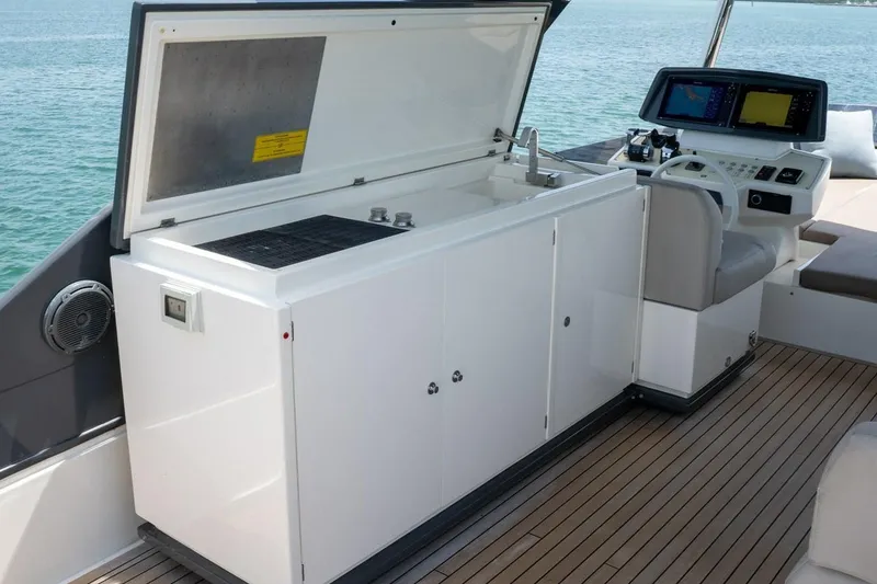 Slide: The Image of Luxury outdoor kitchen and helm on 2020 Ferretti Yachts 670, featuring sleek design and ocean view. - 17