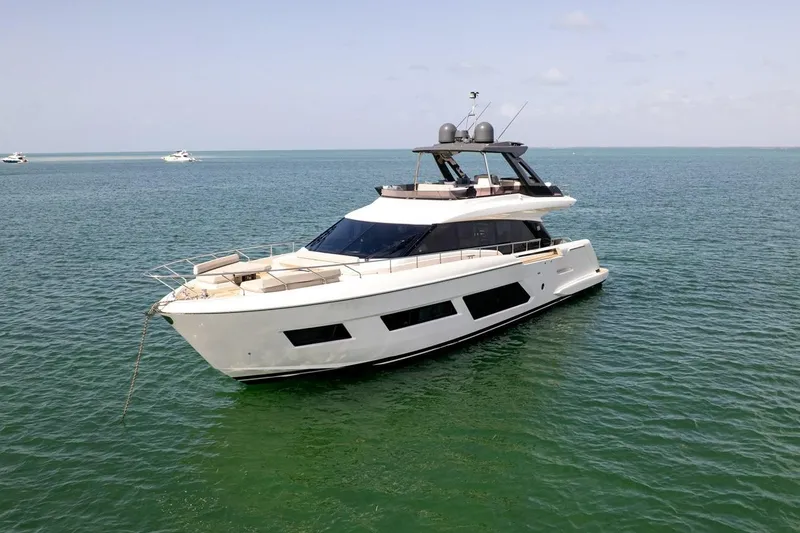Slide: The Image of Luxury 2020 Ferretti Yachts 670 anchored on serene ocean waters. - 10