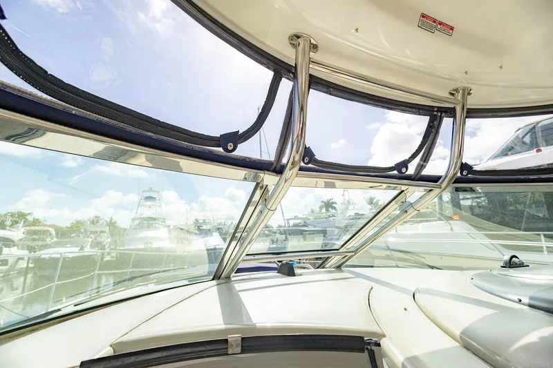Slide: The Image of 2005 Sea Ray 420 Sundancer cockpit view with marina background. - 31