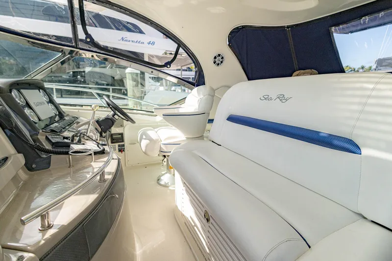Slide: The Image of Interior of 2005 Sea Ray 420 Sundancer yacht with helm and seating area. - 32