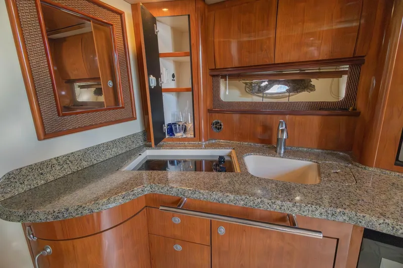 Slide: The Image of Luxurious kitchen area in a 2005 Sea Ray 420 Sundancer yacht with granite countertops. - 18