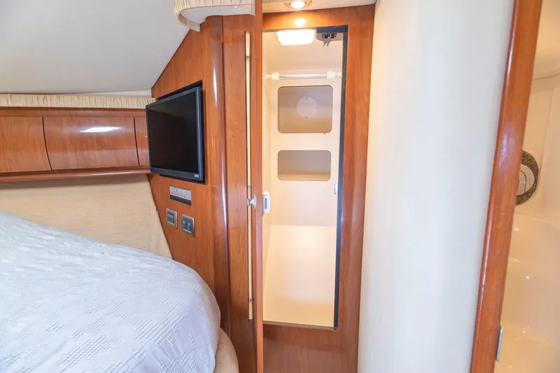 Slide: The Image of Interior cabin of 2005 Sea Ray 420 Sundancer yacht with wood paneling and TV. - 13