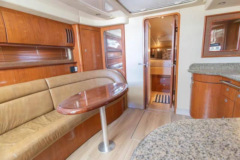 Slide: The Image of Luxurious interior of 2005 Sea Ray 420 Sundancer yacht with wood finishes and cozy seating. - 22