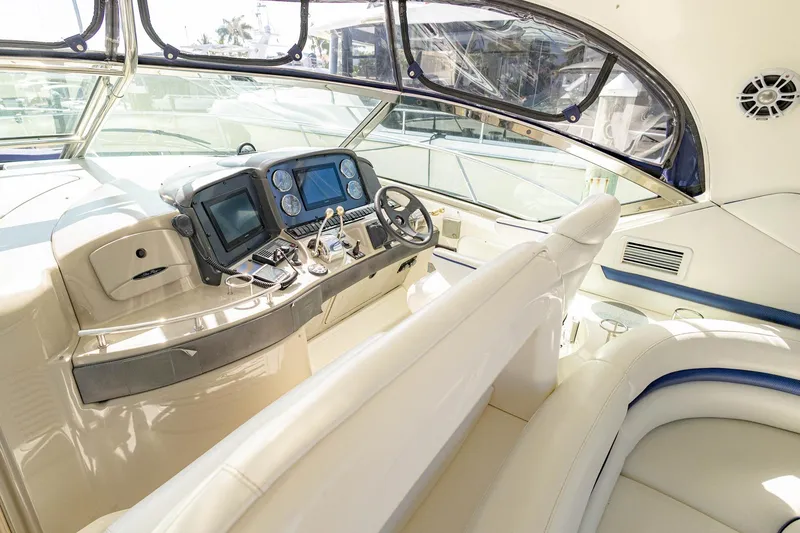 Slide: The Image of 2005 Sea Ray 420 Sundancer helm with modern navigation equipment and luxurious seating. - 30
