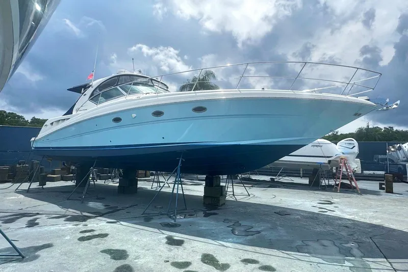 Slide: The Image of 2005 Sea Ray 420 Sundancer yacht on stands, under a cloudy sky. - 39