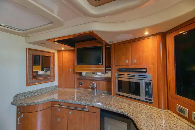 Slide: The Image of Luxurious 2005 Sea Ray 420 Sundancer yacht interior with modern kitchen amenities. - 20