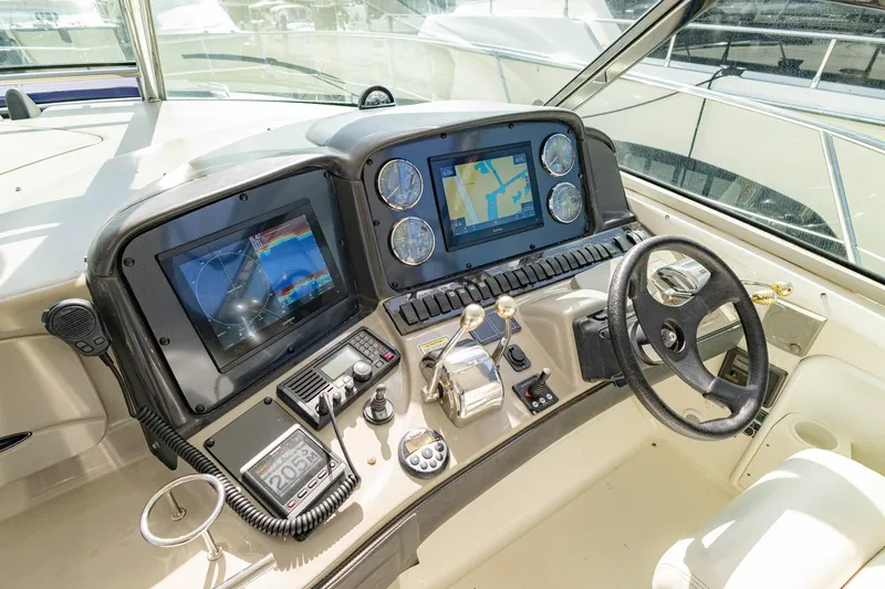 Slide: The Image of Control panel of a 2005 Sea Ray 420 Sundancer yacht with navigation screens. - 27