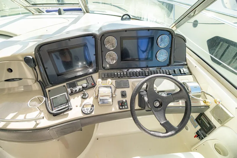 Slide: The Image of Control panel of a 2005 Sea Ray 420 Sundancer yacht with steering wheel and gauges. - 29