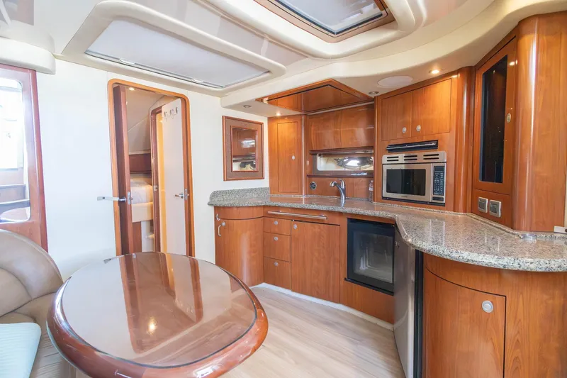 Slide: The Image of Luxurious 2005 Sea Ray 420 Sundancer yacht interior with modern kitchen and elegant wood finishes. - 21