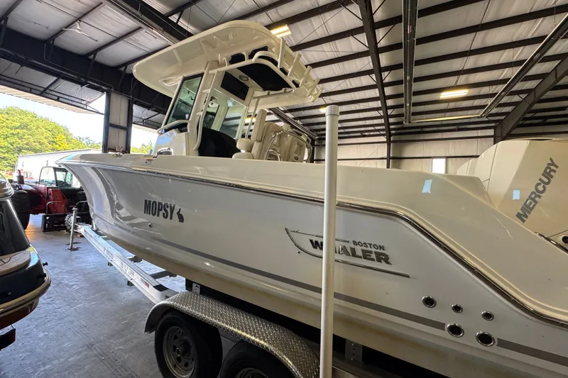 Slide: The Image of 2021 Boston Whaler 250 Outrage boat in a warehouse, on a trailer. - 34