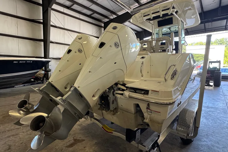 Slide: The Image of 2021 Boston Whaler 250 Outrage boat with dual engines in a storage facility. - 32
