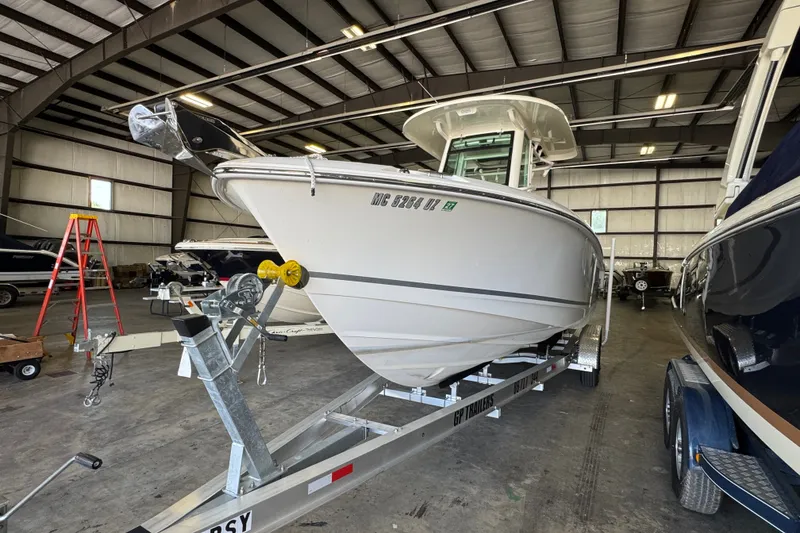 Slide: The Image of 2021 Boston Whaler 250 Outrage boat on trailer in indoor storage facility. - 35
