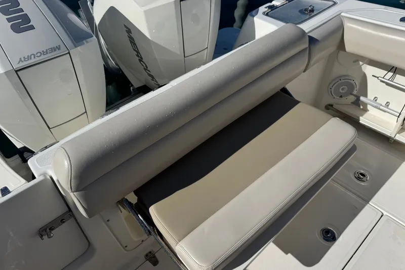 Slide: The Image of 2021 Boston Whaler 250 Outrage boat with dual Mercury engines and cushioned seating. - 10