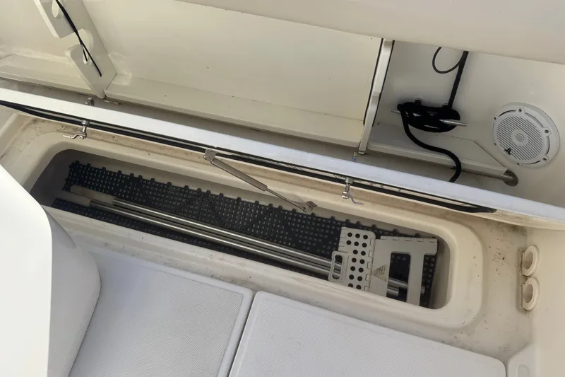 Slide: The Image of Storage compartment on a 2021 Boston Whaler 250 Outrage boat, featuring organized equipment. - 9