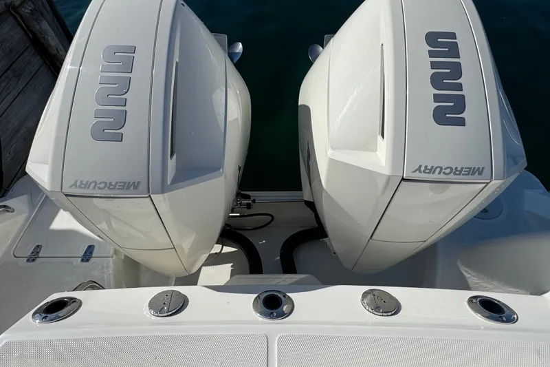 Slide: The Image of Twin Mercury outboard engines on a 2021 Boston Whaler 250 Outrage boat. - 12
