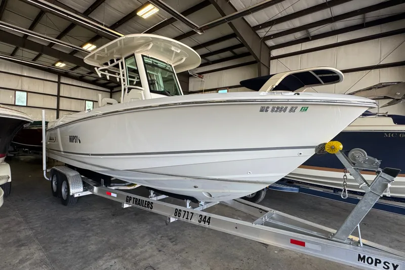 Slide: The Image of 2021 Boston Whaler 250 Outrage boat on trailer in indoor storage facility. - 31
