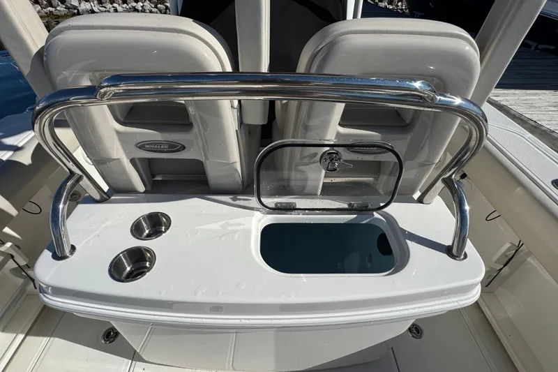 Slide: The Image of 2021 Boston Whaler 250 Outrage boat interior with seating and storage features. - 15