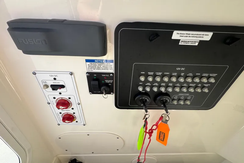 Slide: The Image of Control panel of a 2021 Boston Whaler 250 Outrage boat with switches and labels. - 21